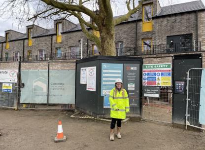 Woman standing infront of a construction site