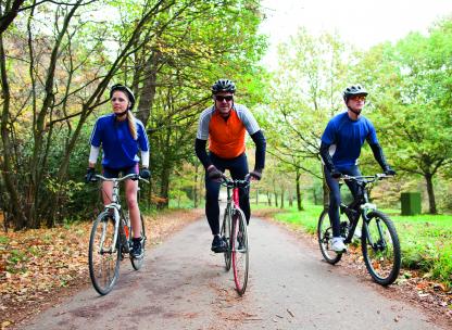 Friends riding bikes in the park