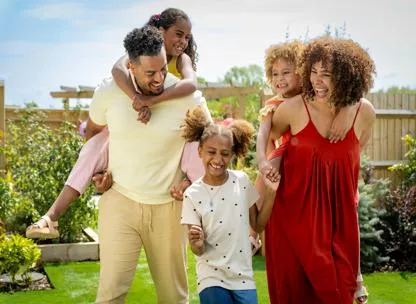 Young family with three children in the garden of their home at Canalside Quarter