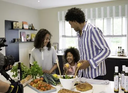 Dad and two children cooking together in a modern kitchen at St James development