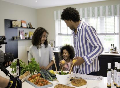 Dad and two children cooking together in a modern kitchen at St James development