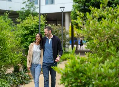 A couple walking through the grounds at The Icon home development