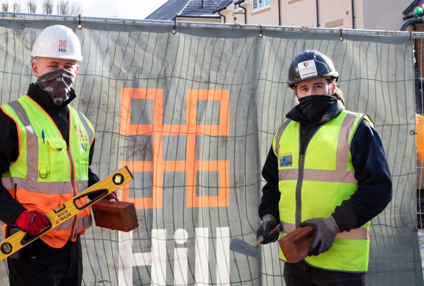 two people stood outside a construction