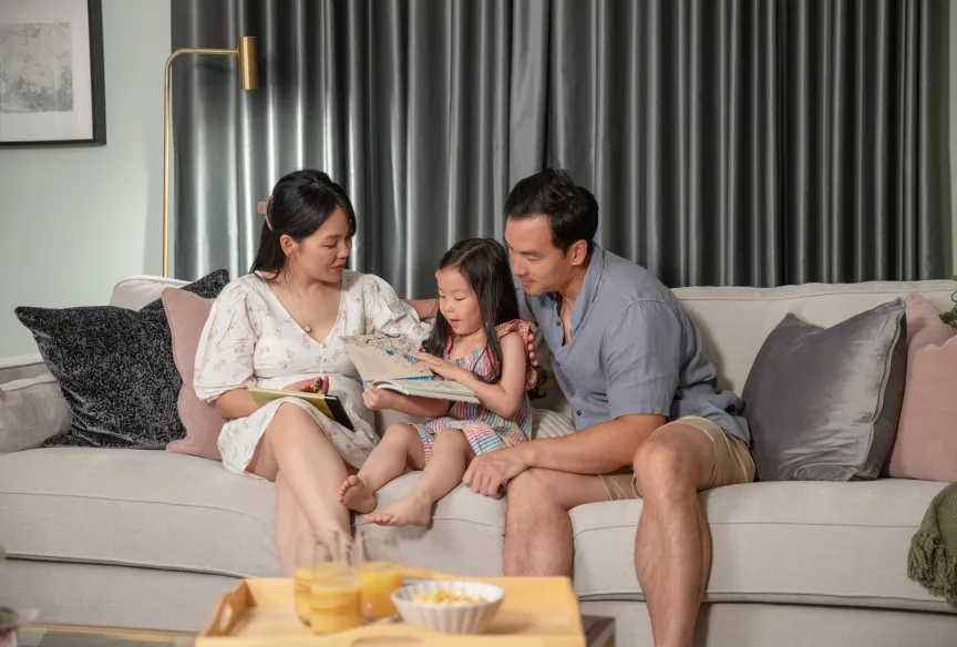 Family sitting on sofa at Marleigh Park, Cambridge 