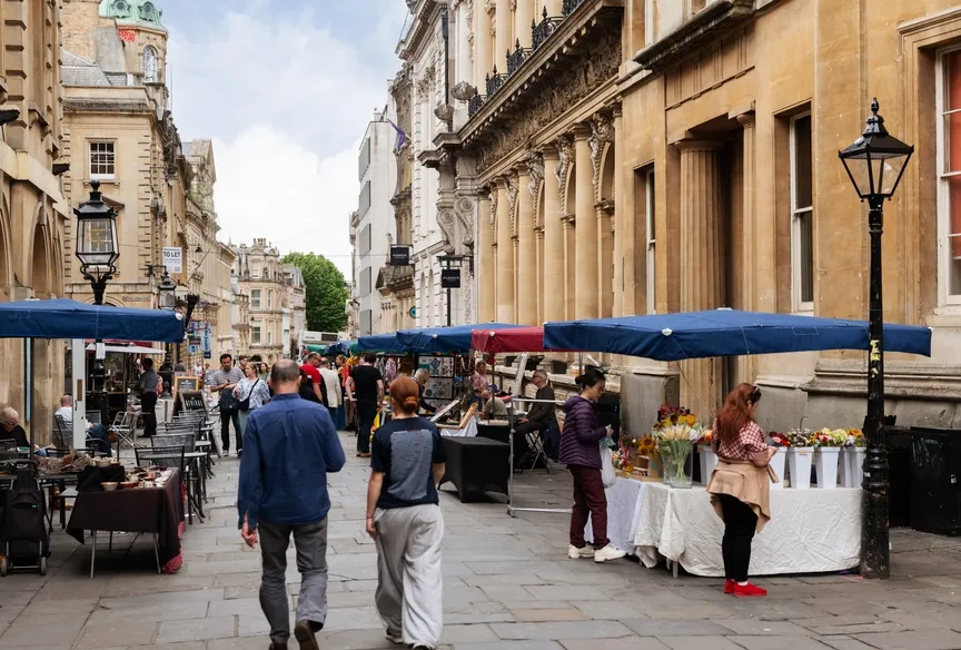 Market stands outside historical buildings in Bristol