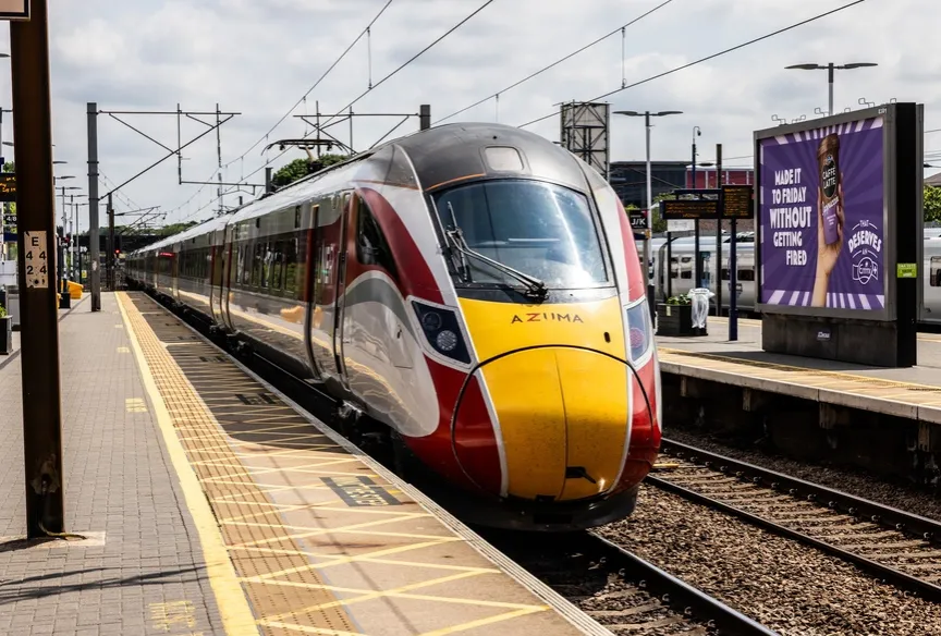 Azuma train passing through railway station