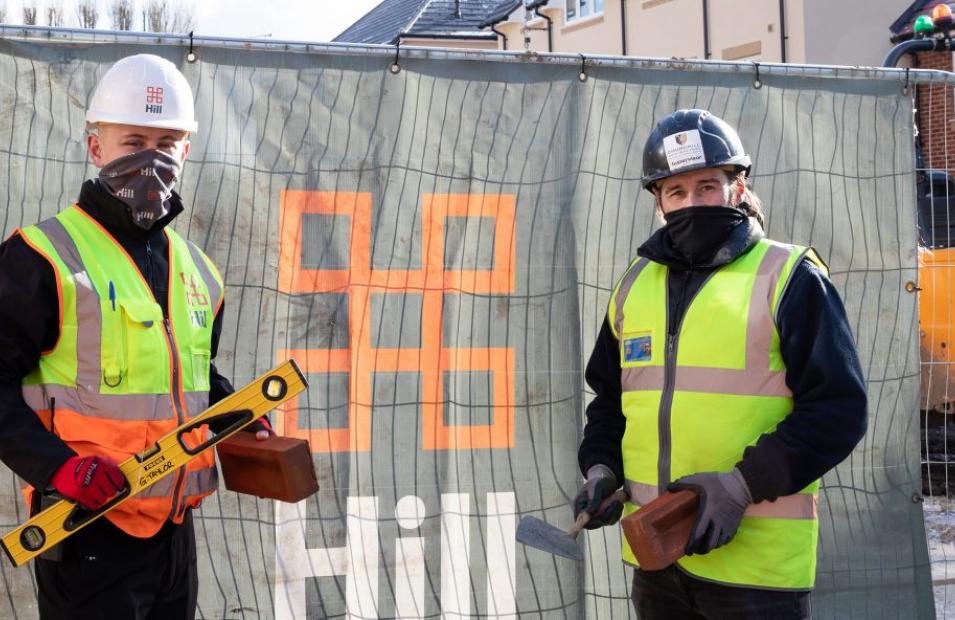 two people stood outside a construction