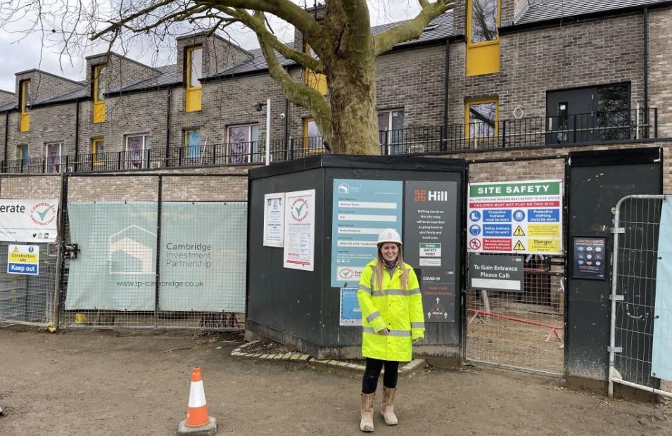 Woman standing infront of a construction site