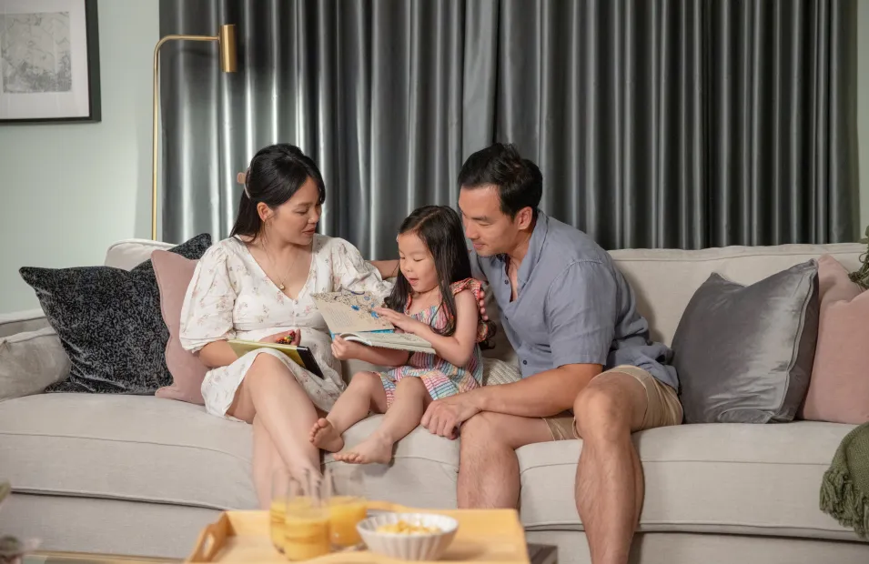 Family sitting on sofa at Marleigh Park, Cambridge 