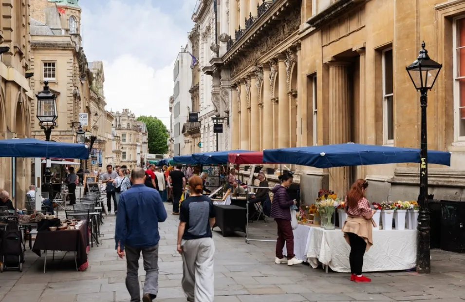 Market stands outside historical buildings in Bristol