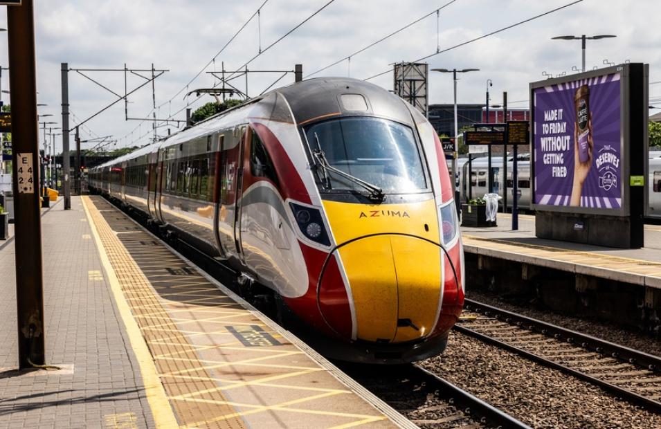 Azuma train passing through railway station