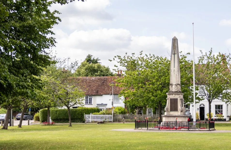 View of Stevenage green with war memorial in the centre and cottages in background