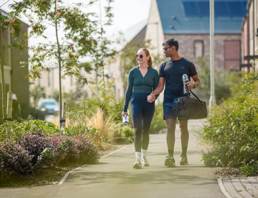 Couple walking down a path on a sunny day 