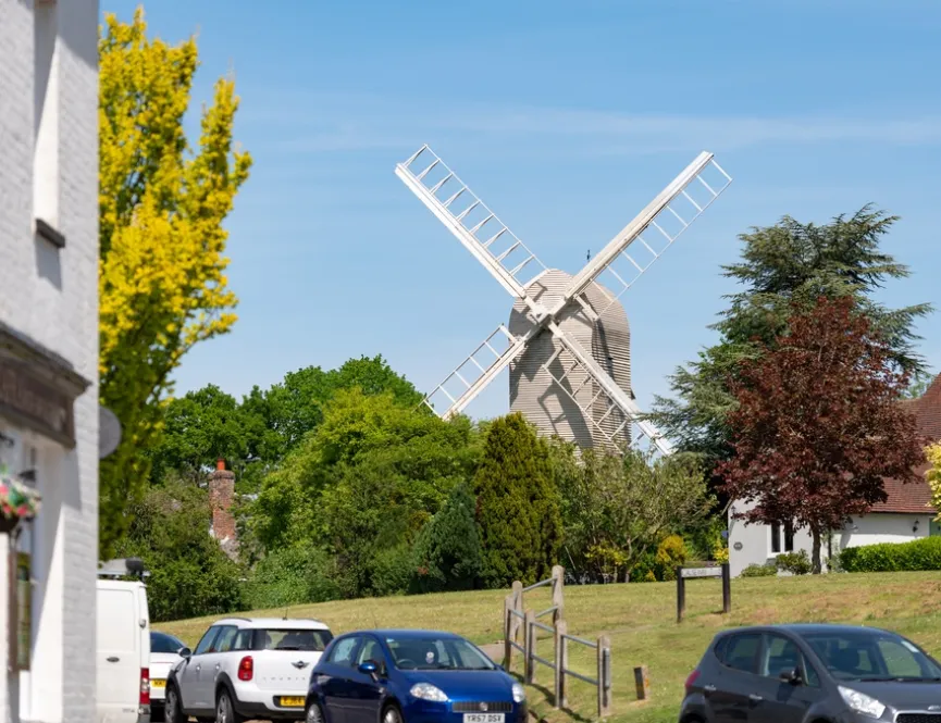View across fields with a white windmill in the background