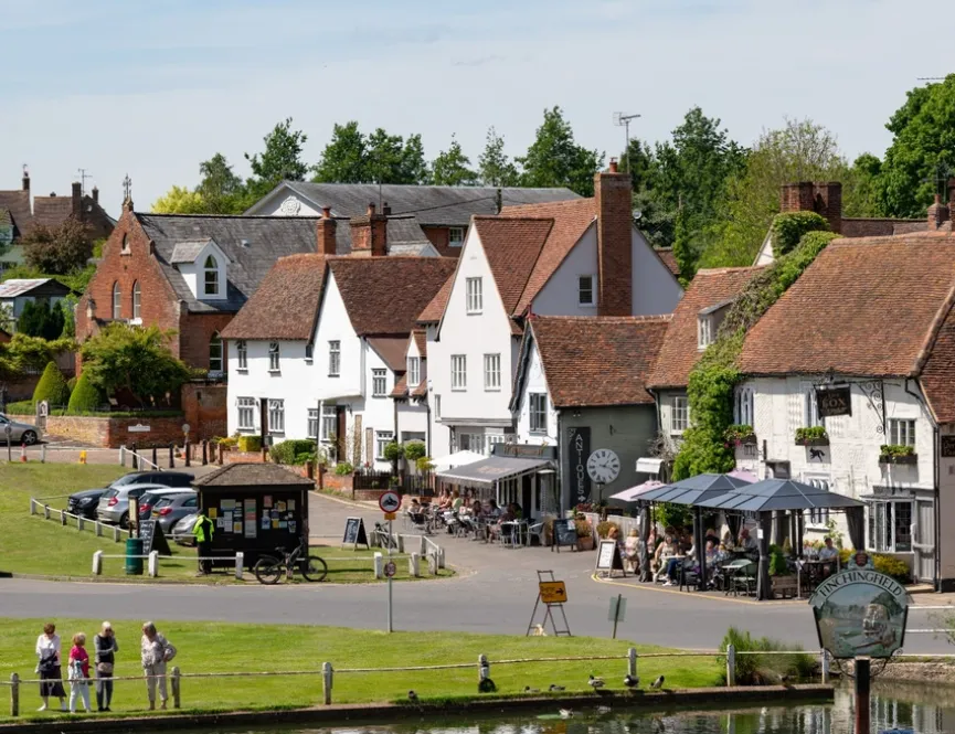 View across pond and village green towards a country pub