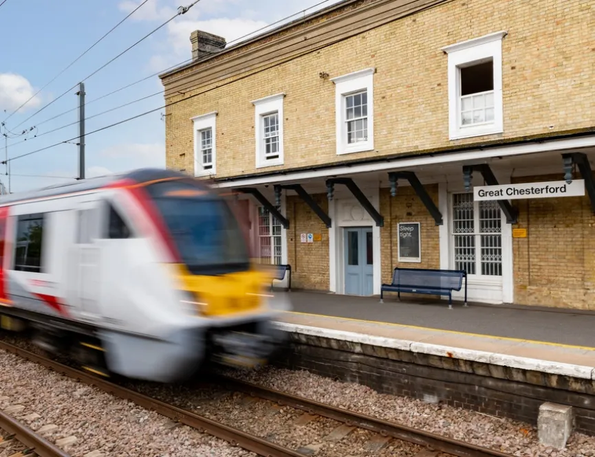 Great Chesterford railway station with blurred train passing through