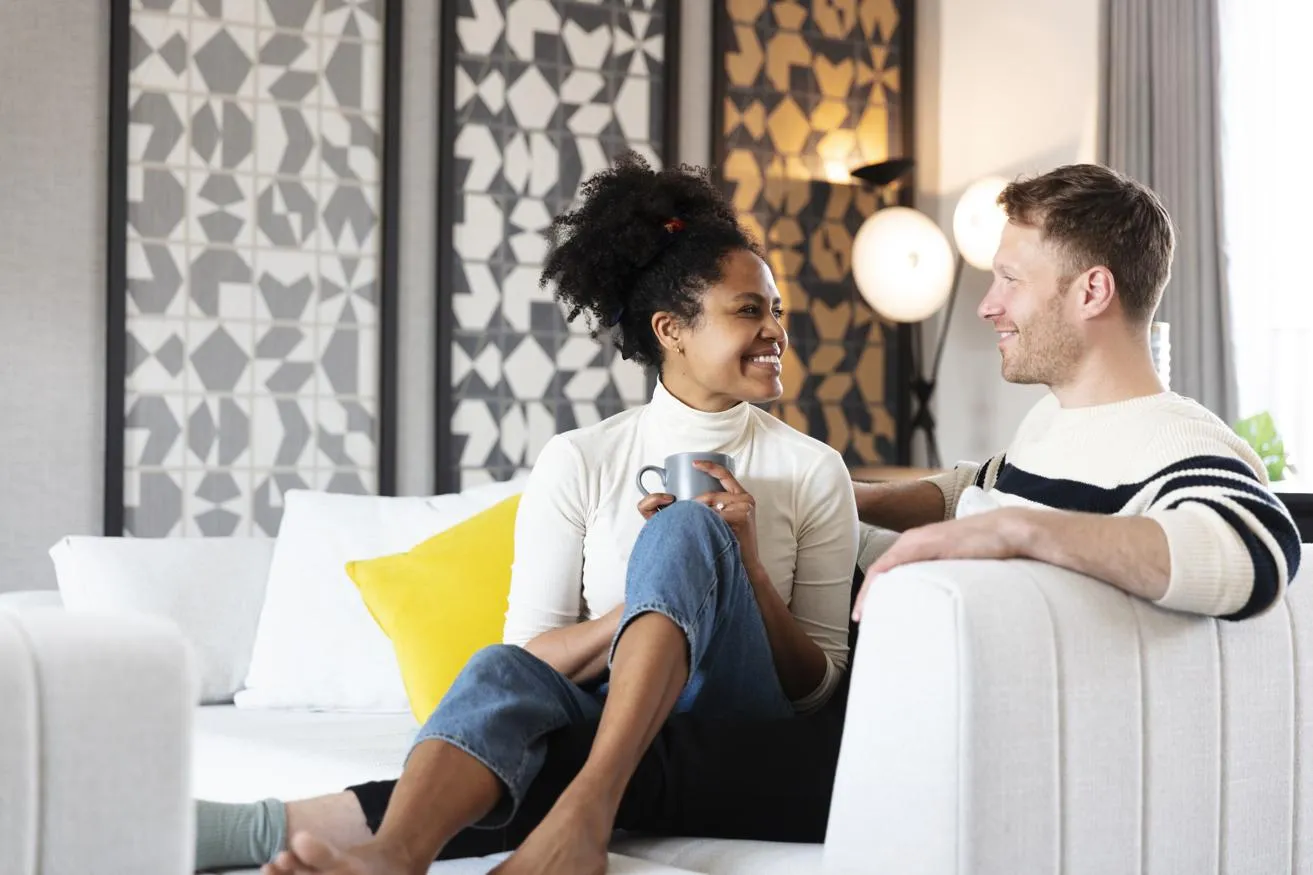 Young couple enjoying a coffee in their lounge at Knights Park home